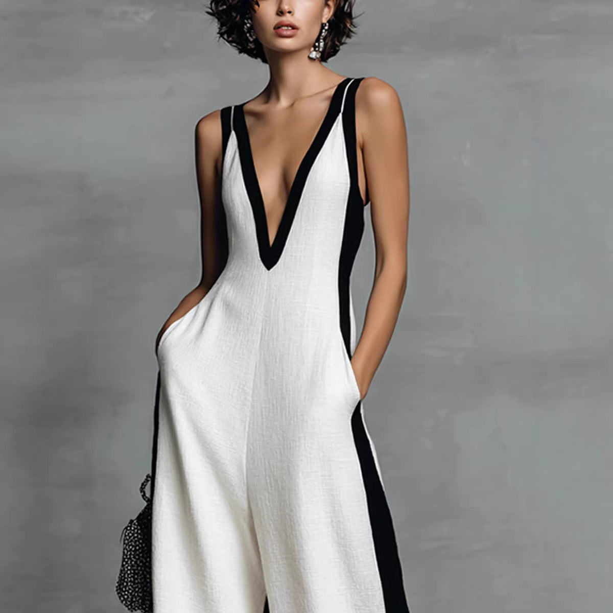 Woman wearing a white dress with black accents against a gray background