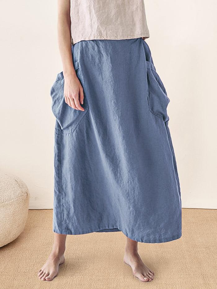 Person wearing a blue skirt with a neutral background