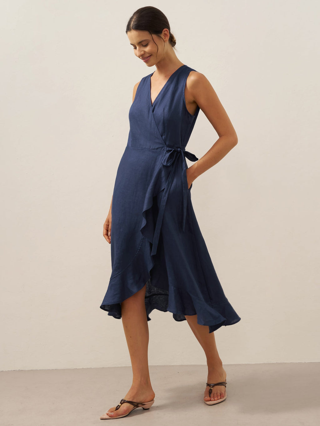 Woman wearing a blue dress against a plain background