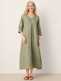 Woman wearing a green dress against a white background