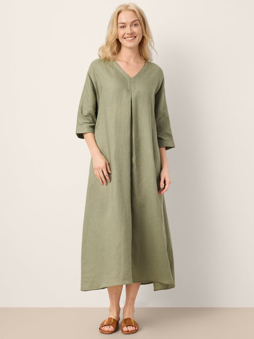 Woman wearing a green dress against a white background