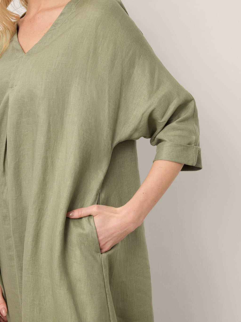 Green dress worn by a person with a neutral background