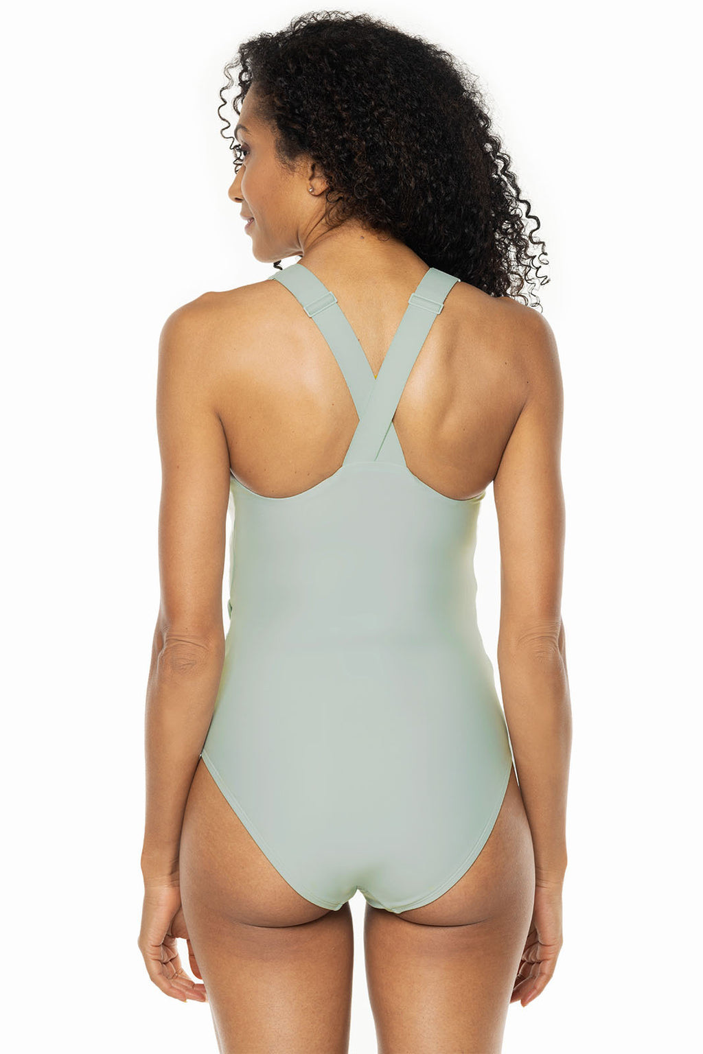 Woman wearing a light green one-piece swimsuit on a white background