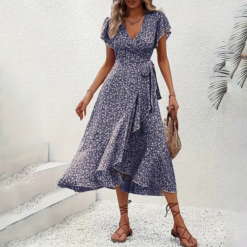 Woman wearing a blue floral dress with a white background