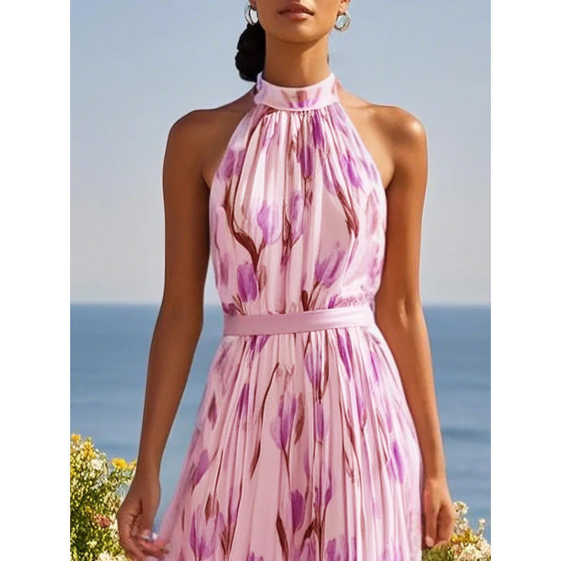 Woman wearing a pink floral dress with a blue sky and ocean background