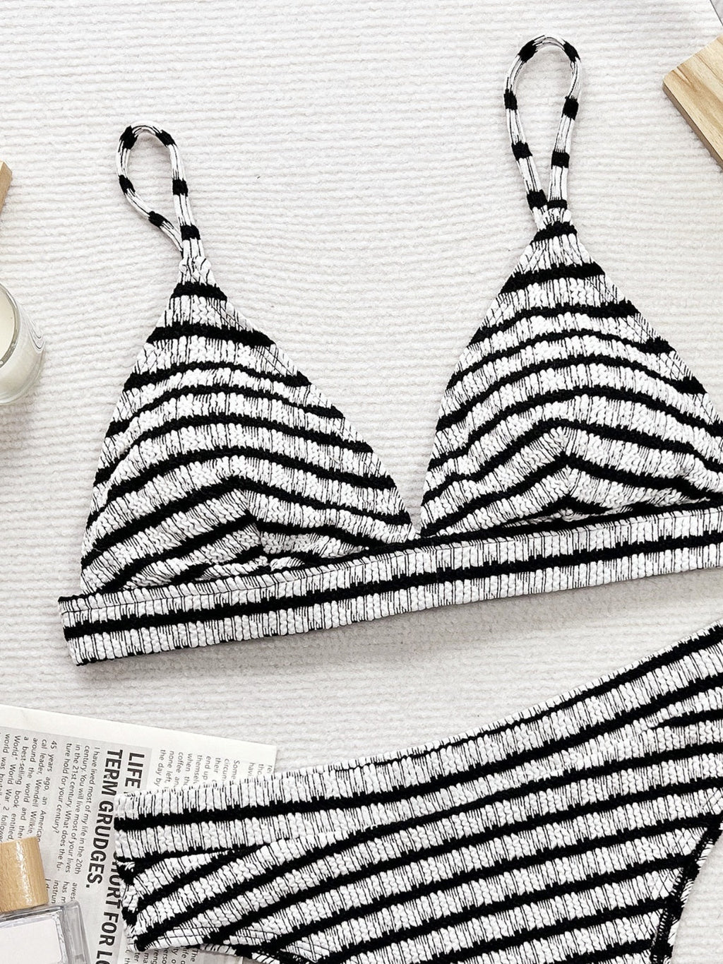 Black and white striped bikini top on a light background