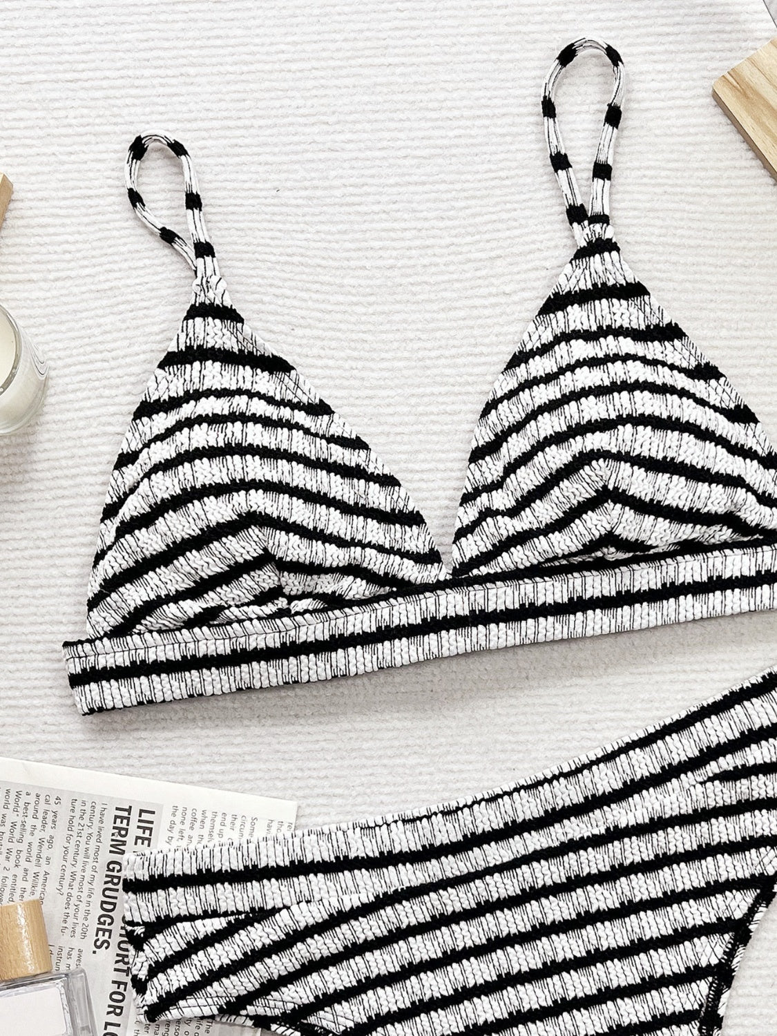 Black and white striped bikini top on a light background