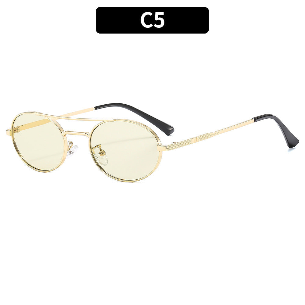 Gold-framed sunglasses with yellow lenses on a white background