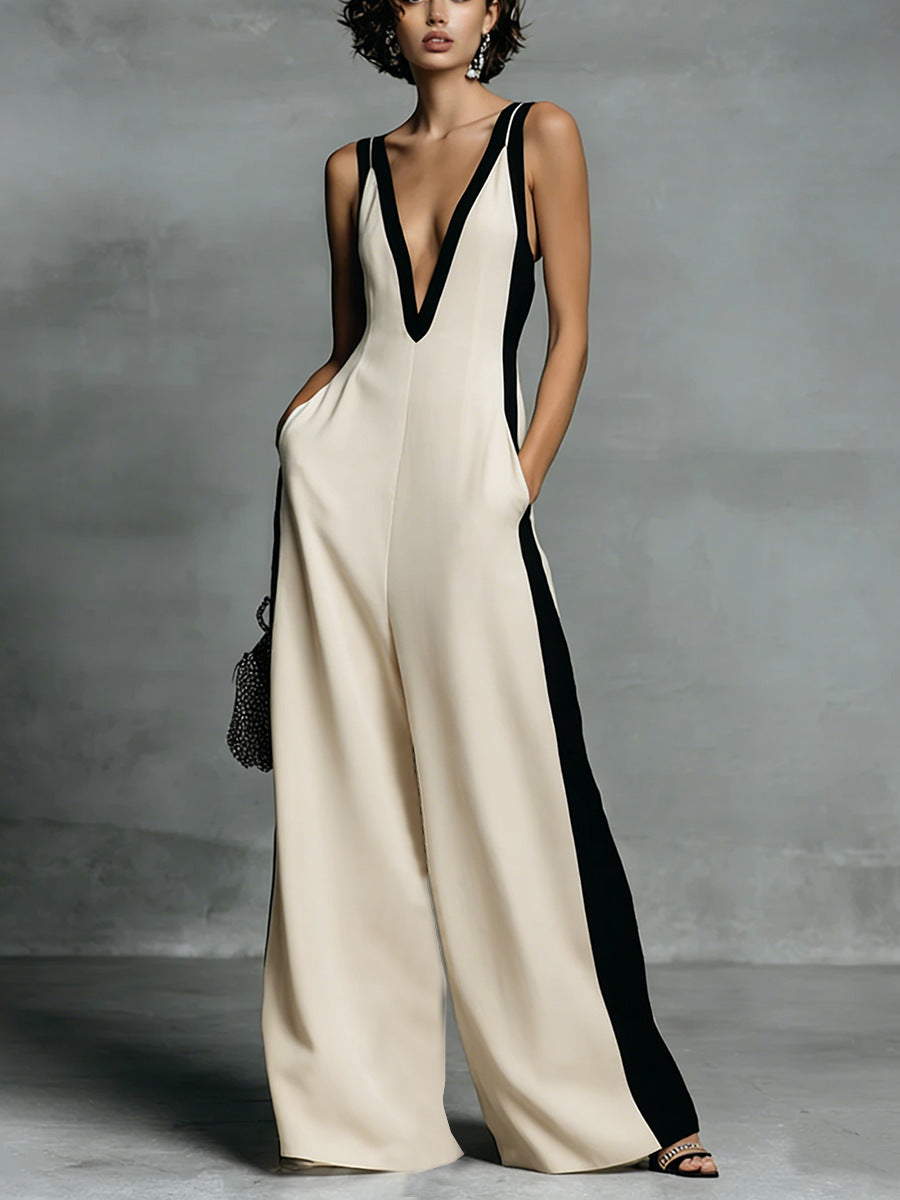 Woman wearing a black and white jumpsuit against a gray background