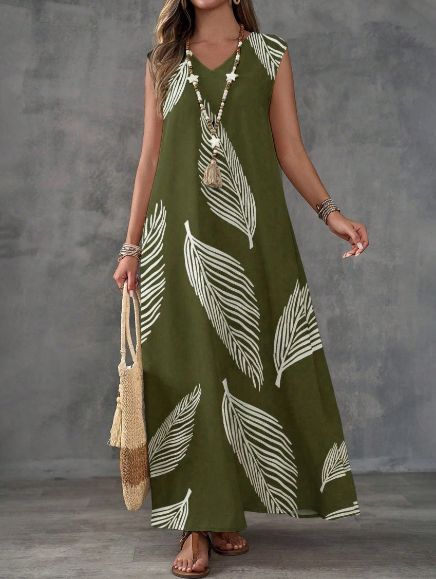 Woman wearing a green dress with white leaf patterns against a gray background