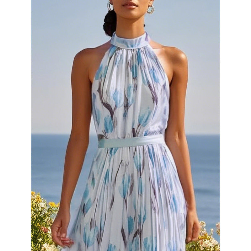 Woman wearing a blue floral dress with a blue sky and ocean background
