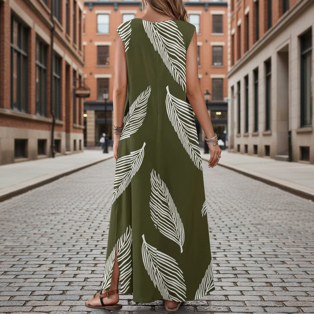 Woman wearing a green dress with white leaf patterns on a city street.