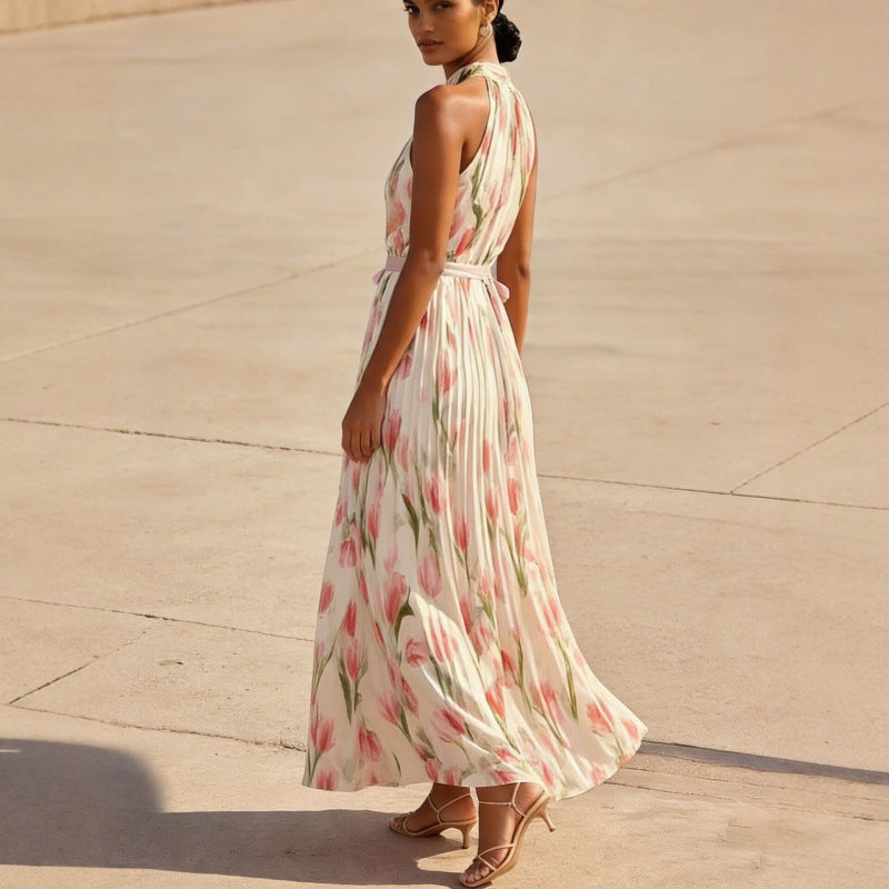 Woman wearing a floral dress standing on a concrete surface