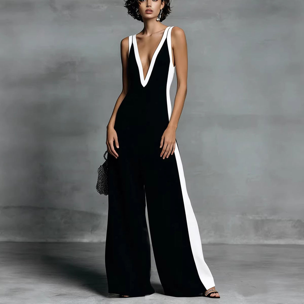 Woman wearing a black and white jumpsuit against a gray background