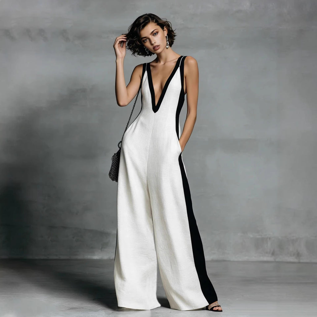 Woman wearing a white and black jumpsuit against a gray background