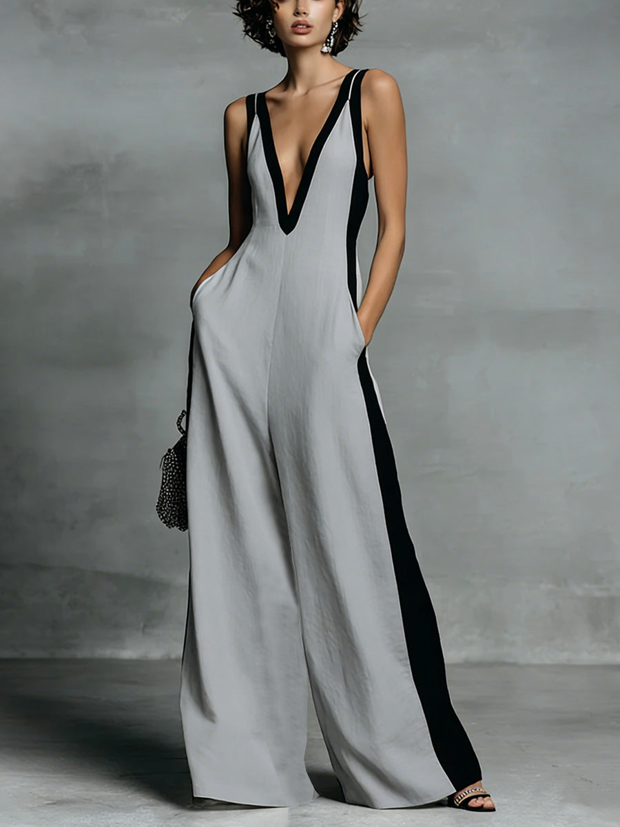 Woman wearing a gray and black jumpsuit against a neutral background