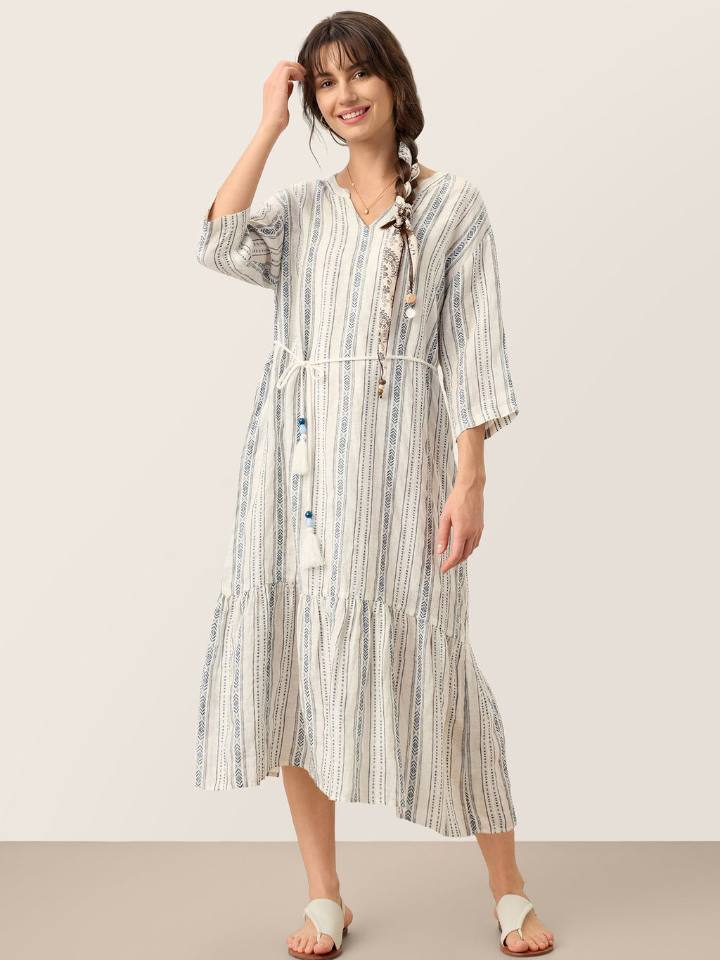 Woman wearing a striped dress with a white background