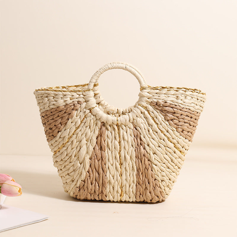 Woven handbag with a handle on a light beige background