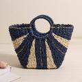 Woven handbag with blue and beige design on a beige background