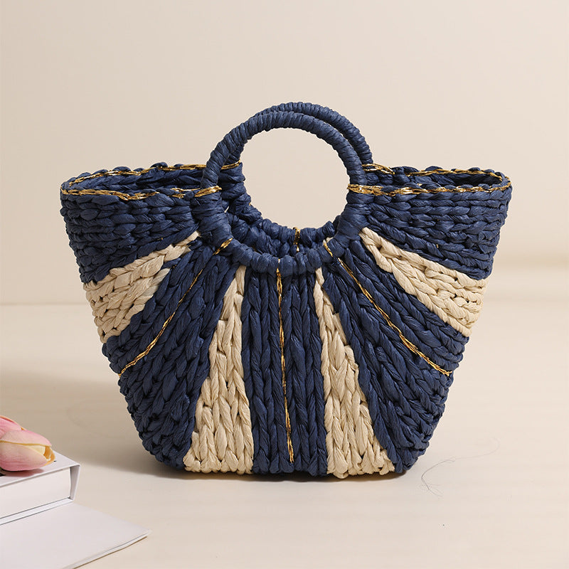 Woven handbag with blue and beige design on a beige background