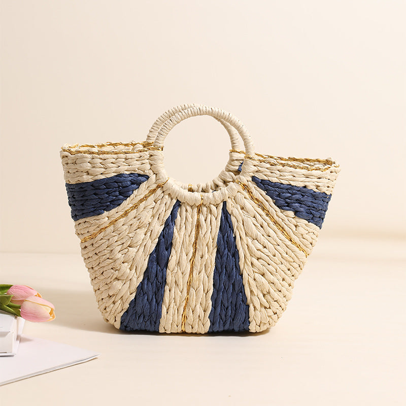 Woven handbag with blue and beige pattern on a light background