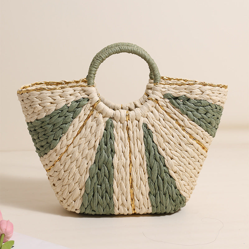 Woven handbag with green and beige pattern on a light background