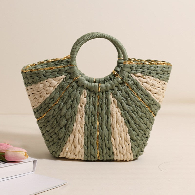Green and beige woven handbag on a light background
