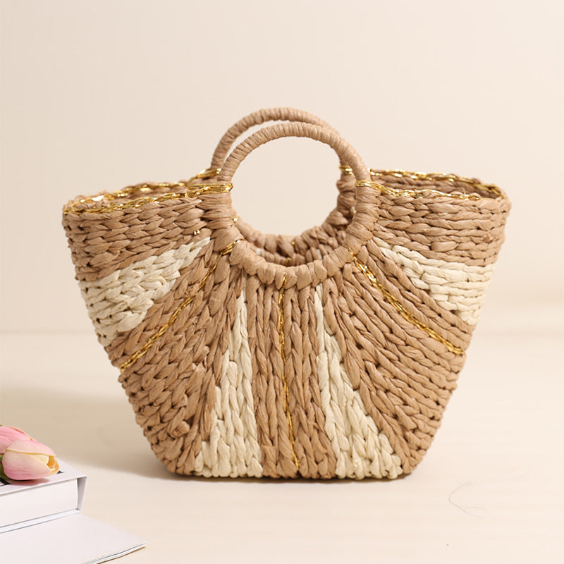 Woven handbag with a handle on a light beige background