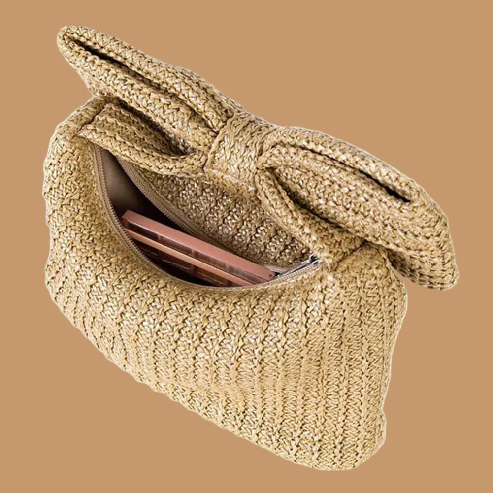 Beige woven handbag with a large bow on a white background