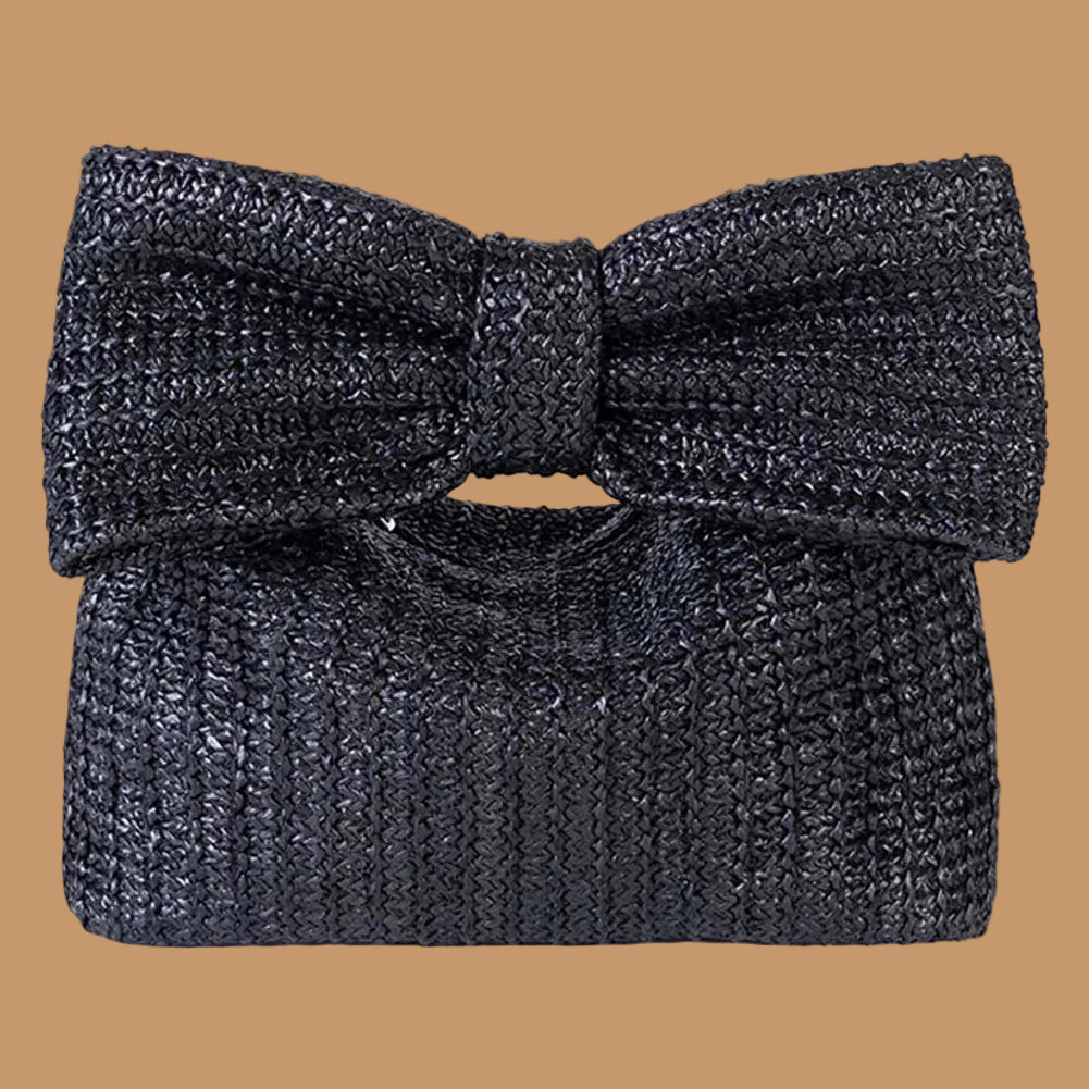 Black textured clutch bag with a large bow on a white background