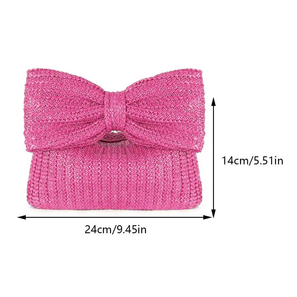 Pink knitted bow clutch with dimensions on a white background