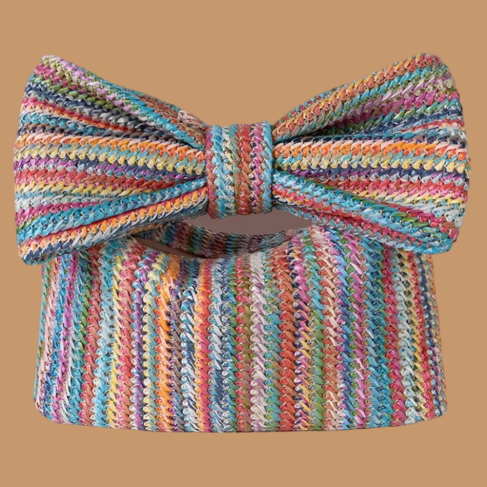 Multicolored striped bow purse on a brown background