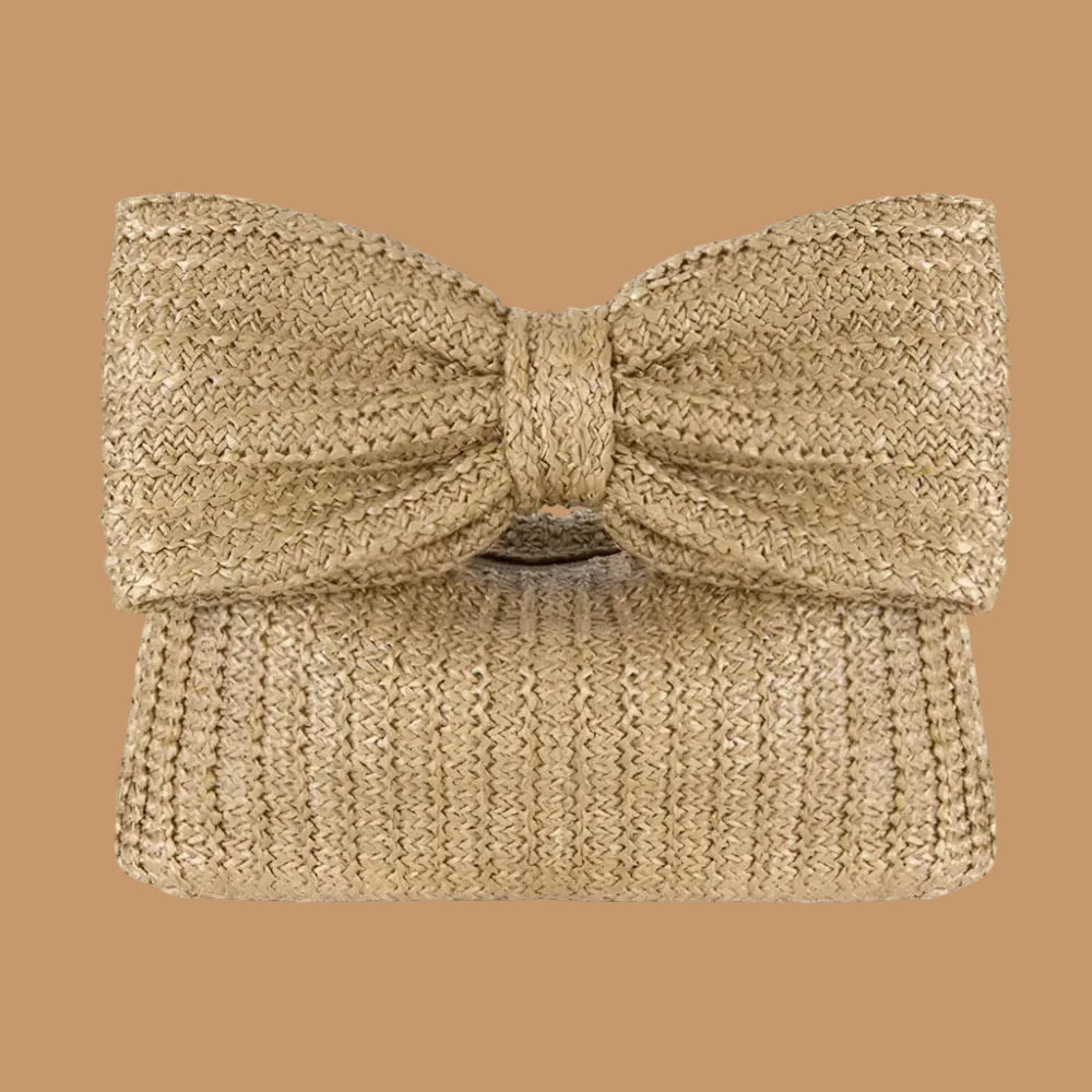 Beige woven clutch bag with a large bow on a white background
