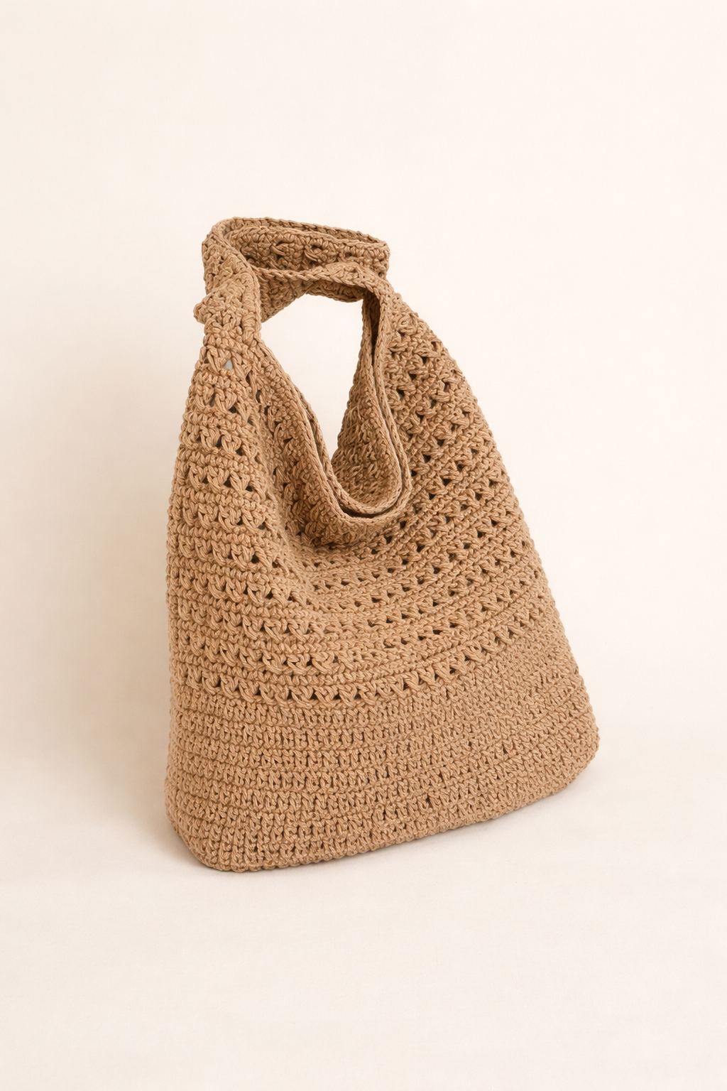 Brown crochet handbag on a beige background