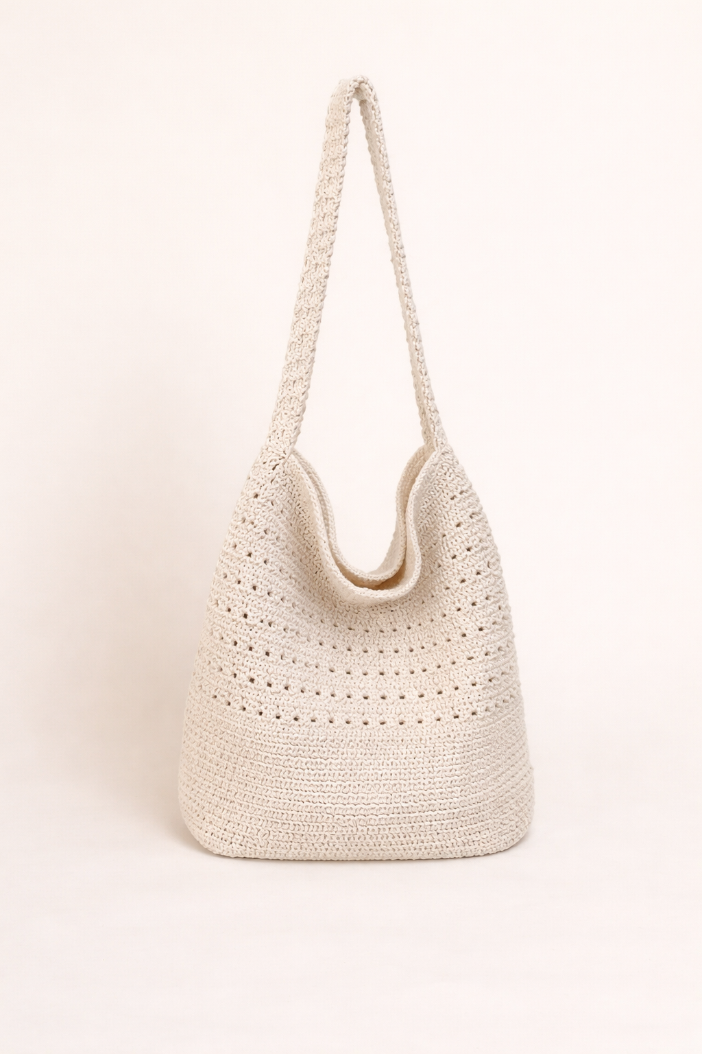 White woven handbag on a light beige background
