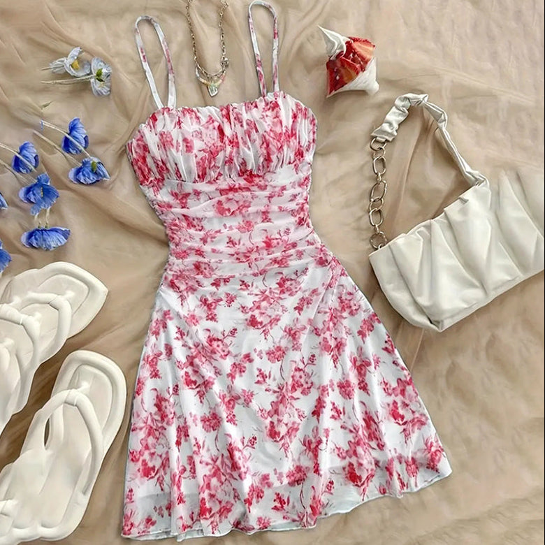 Floral dress with accessories on a beige surface