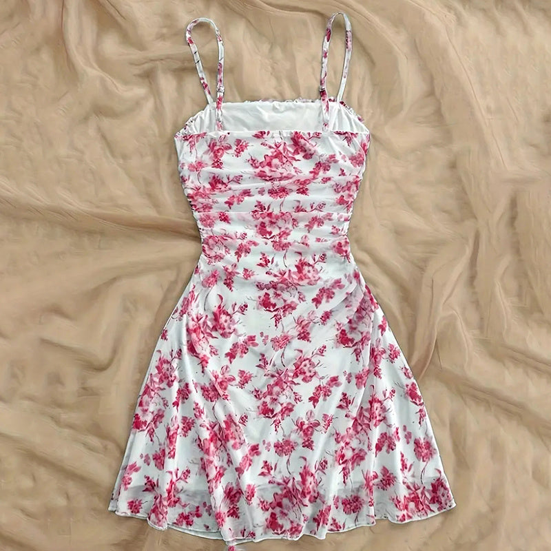 Red and white floral dress turned back on a beige surface