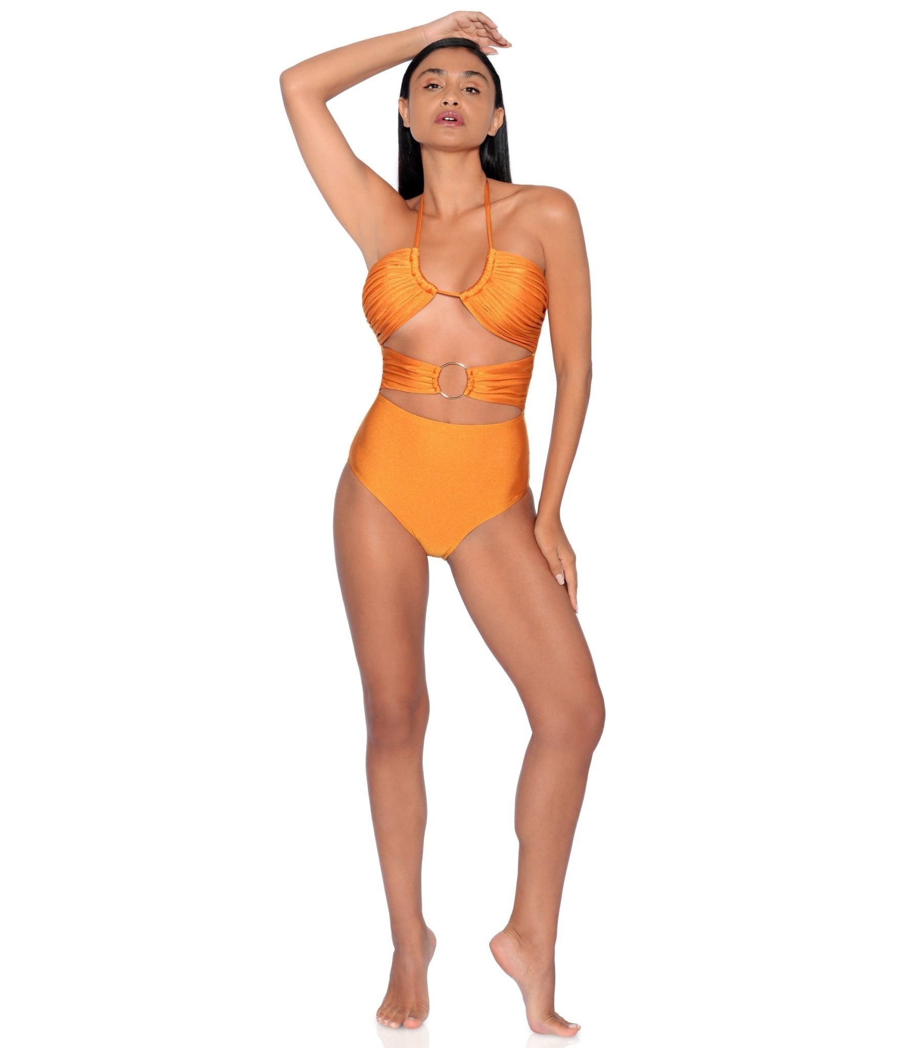 Woman wearing an orange bikini set on a white background