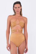 Woman wearing a mustard yellow bikini with a white background