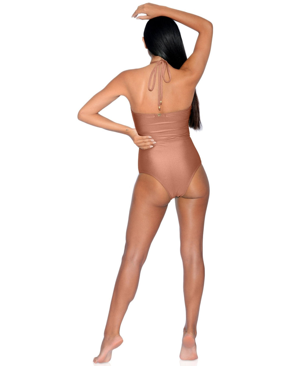 Person wearing a brown bodysuit on a white background
