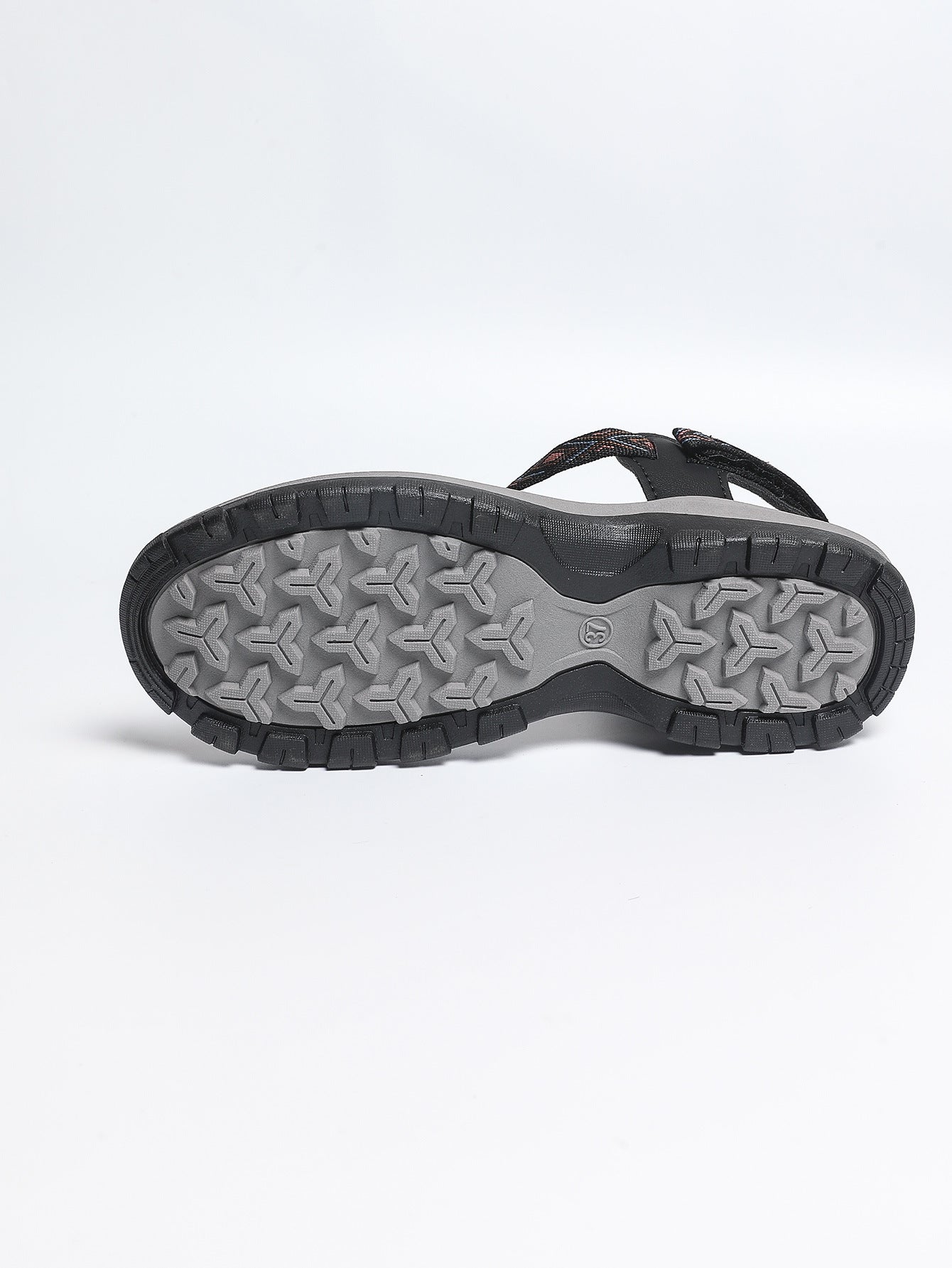 Black sandal with gray sole on a white background