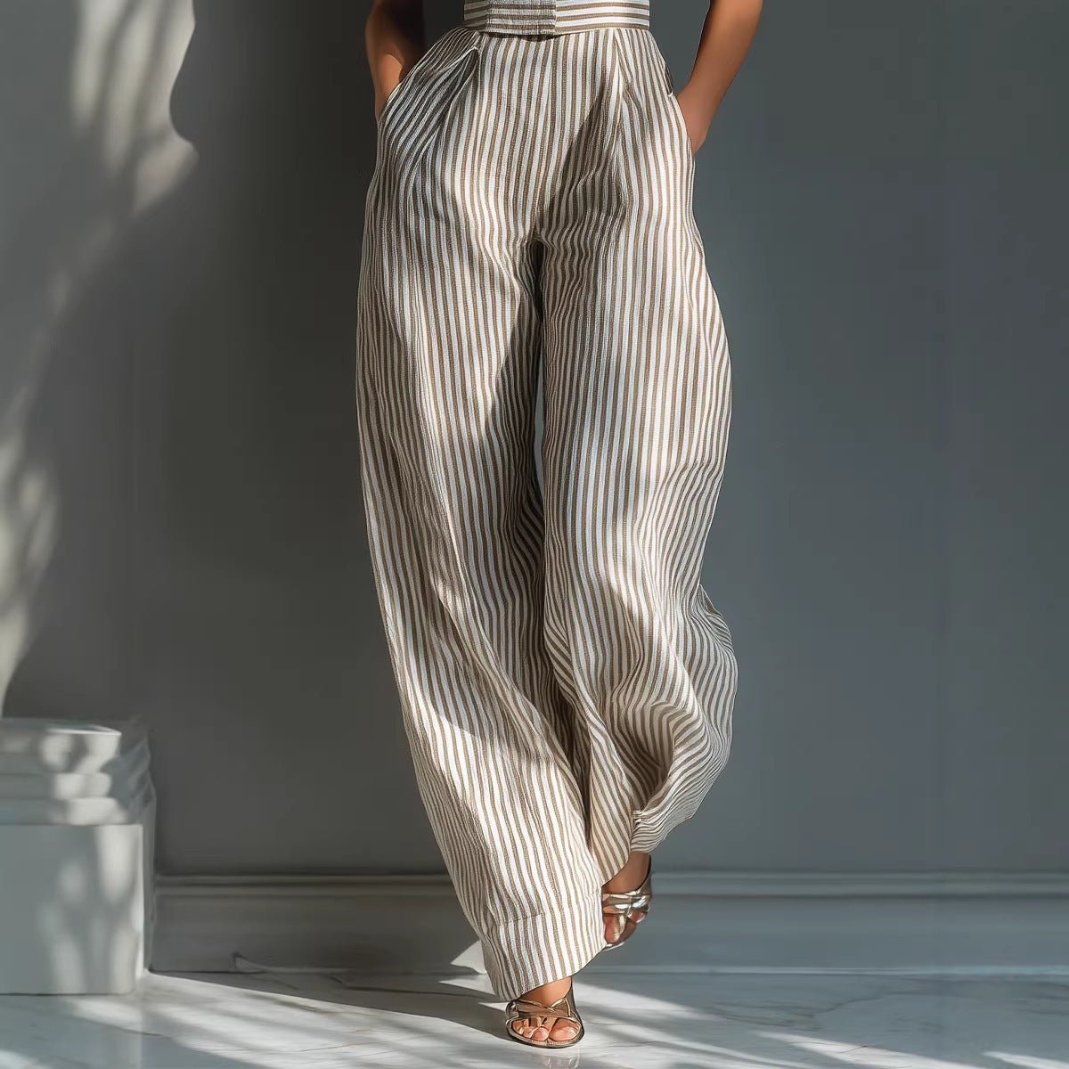 Woman wearing a striped jumpsuit against a neutral background