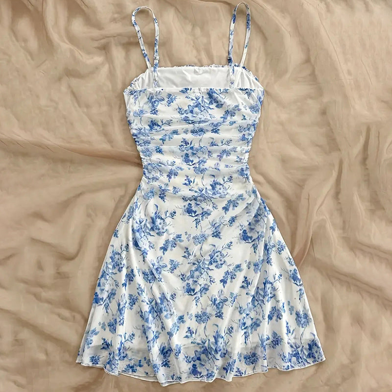 Blue and white floral dress turned back on a beige surface