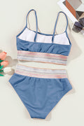 Blue and multicolor striped swimsuit on a white surface