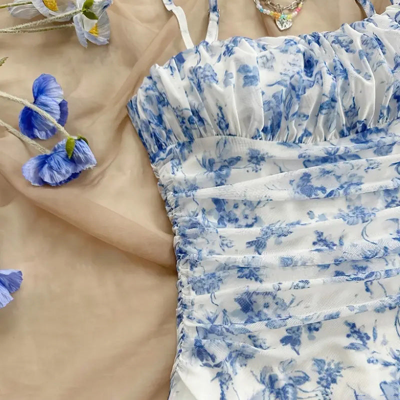 Close-up of a blue and white floral dress with a blurred background with blue flowers