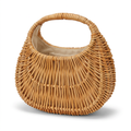 Woven handbag made of natural materials on a white background